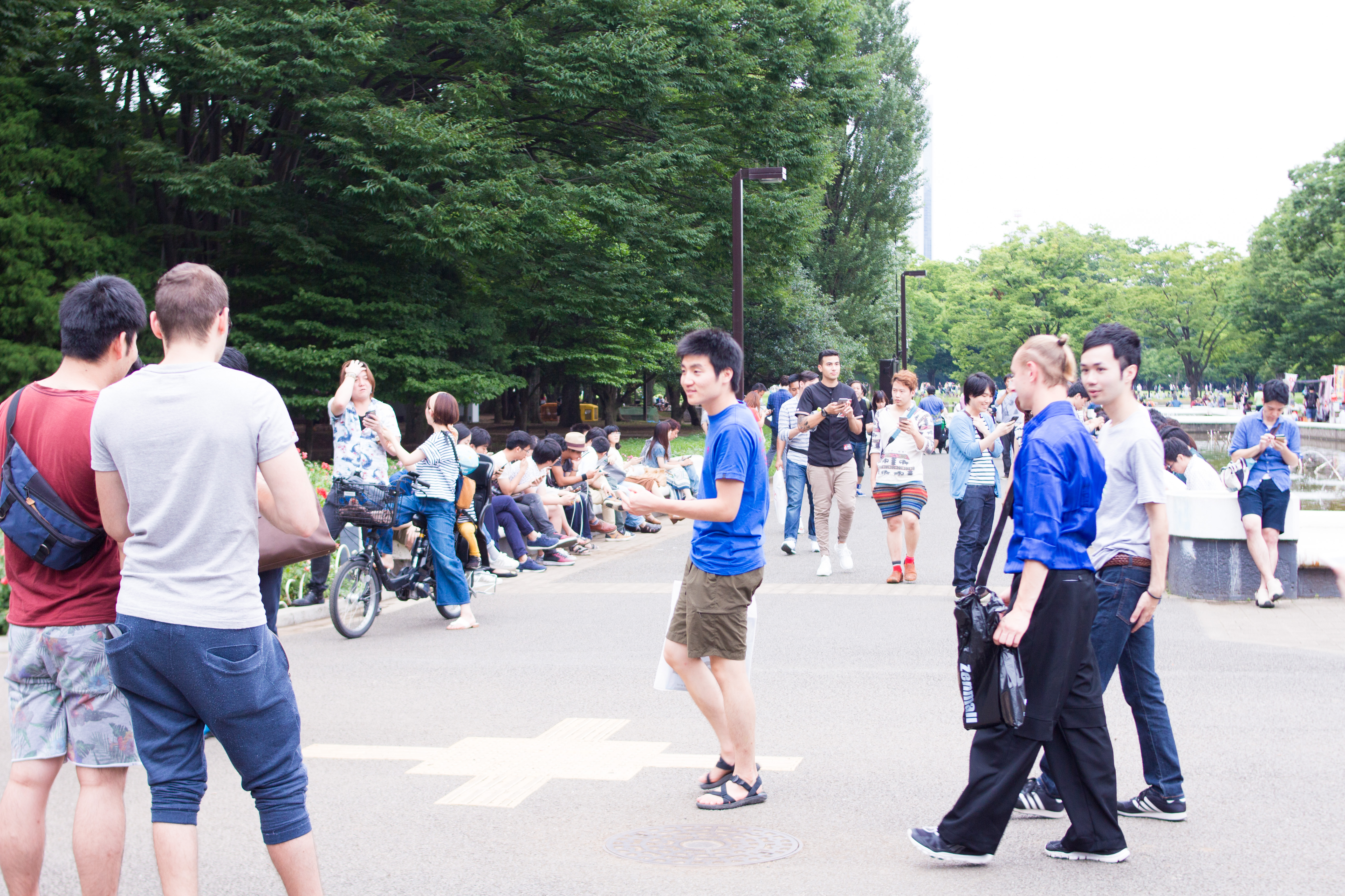 Players look at their phones while gathering for Pokémon Go in Tokyo’s Yoyogi Park in July 2016.