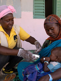 An IRC health worker cares for a nine-month-old Sudanese refugee in Gaga Camp, Chad, in May 2023.