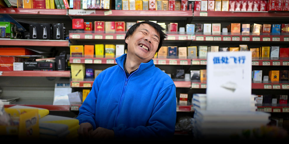 Delivery rider and poet Wang Jibing with copies of his poetry collection Low Flight.