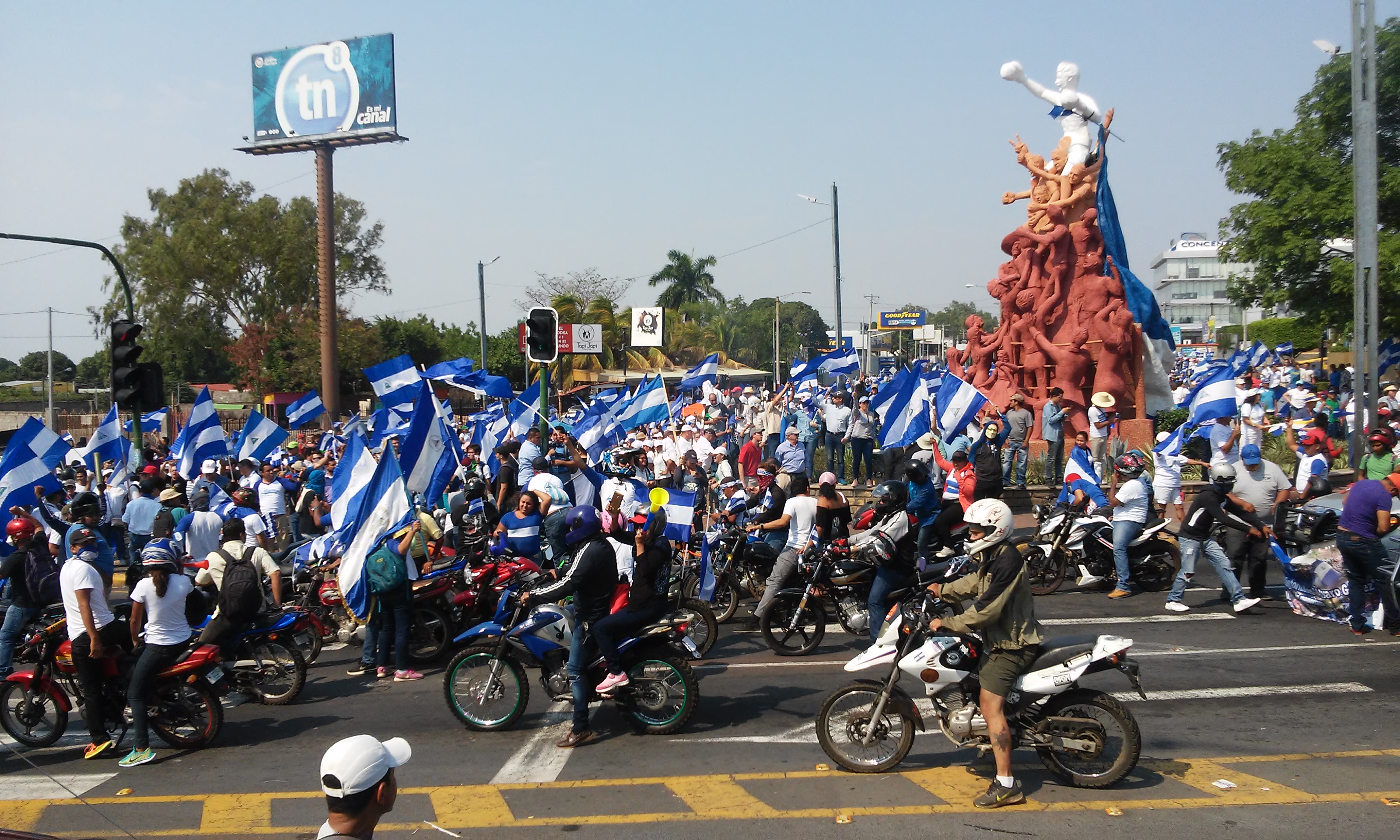 Anti-government protesters carrying Nicaraguan flags fill a road in Managua on May 9, 2018.