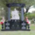 Large headstone statue with black granite, white text, and a large grey granite statue of a saint dallas fort worth texas
