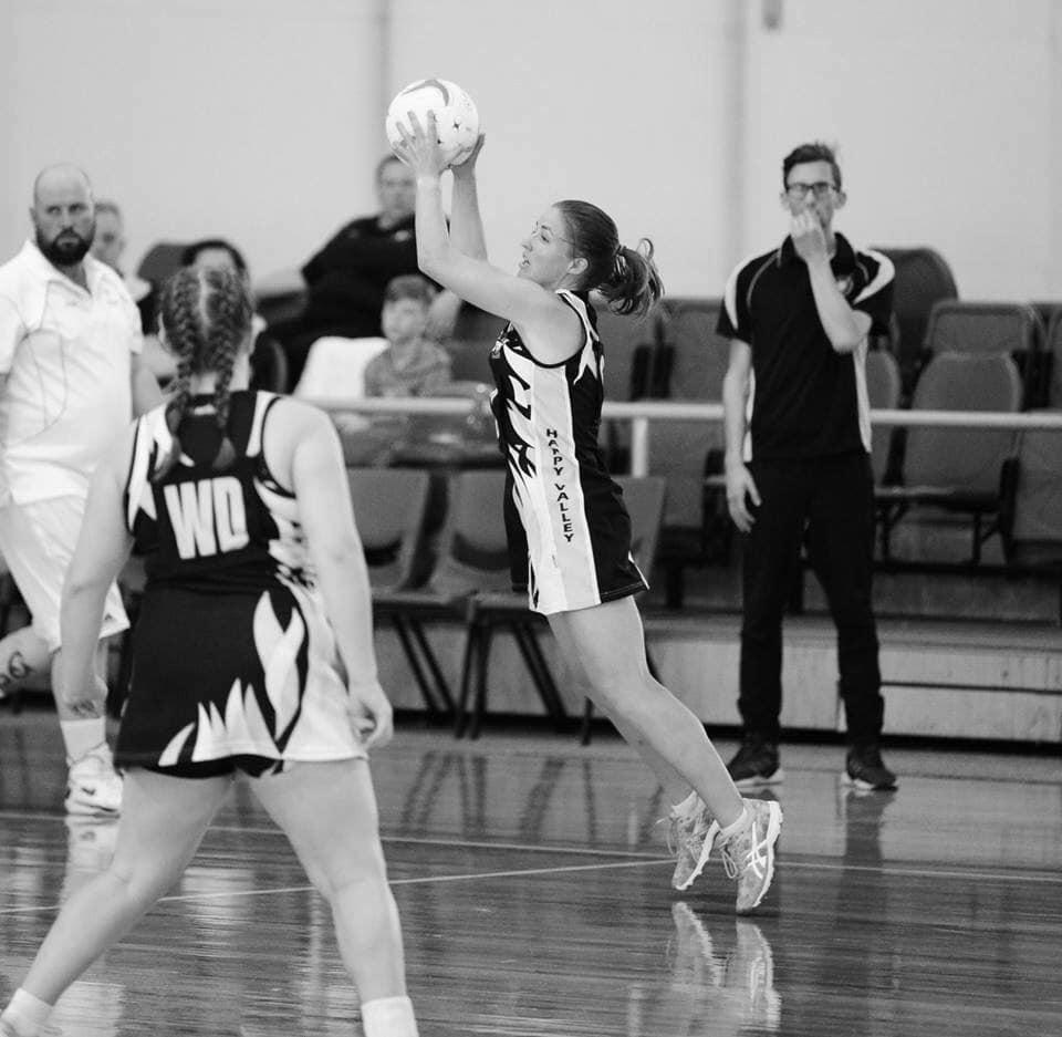 Player shooting for goal in black and white