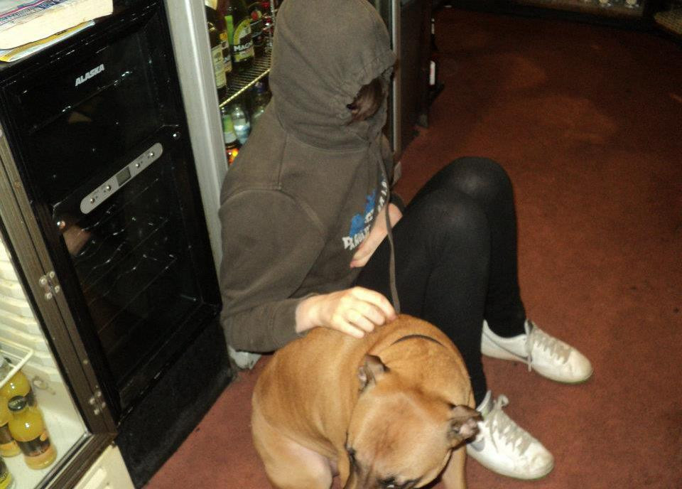 Hannah with a dog behind the bar