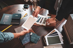 People comparing fabric swatches for their suit