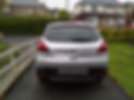 Silver Peugeot with a dent on the back
