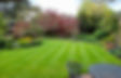 Well maintained garden with flower beds and lawn