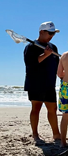 Jason at the beach with lacrosse stick