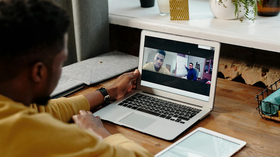 A man participates in an online video conference call from home using his laptop, fostering remote communication.