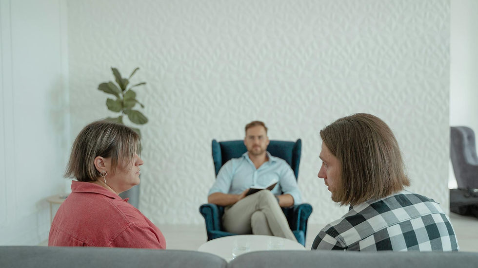 Image of a counseling session with a professional advisor, focusing on a couple's discussion.