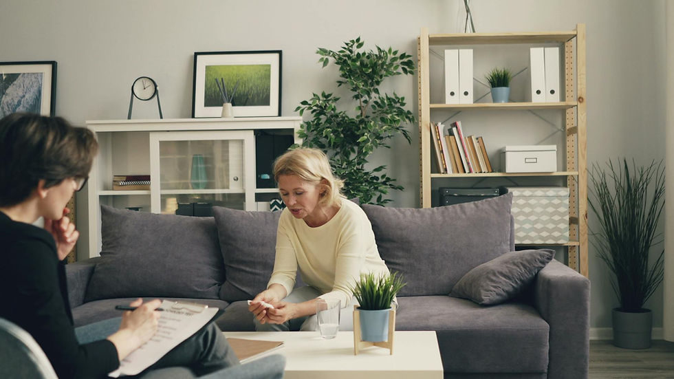 A woman consults with a therapist in a modern, cozy home setting, focusing on mental health.