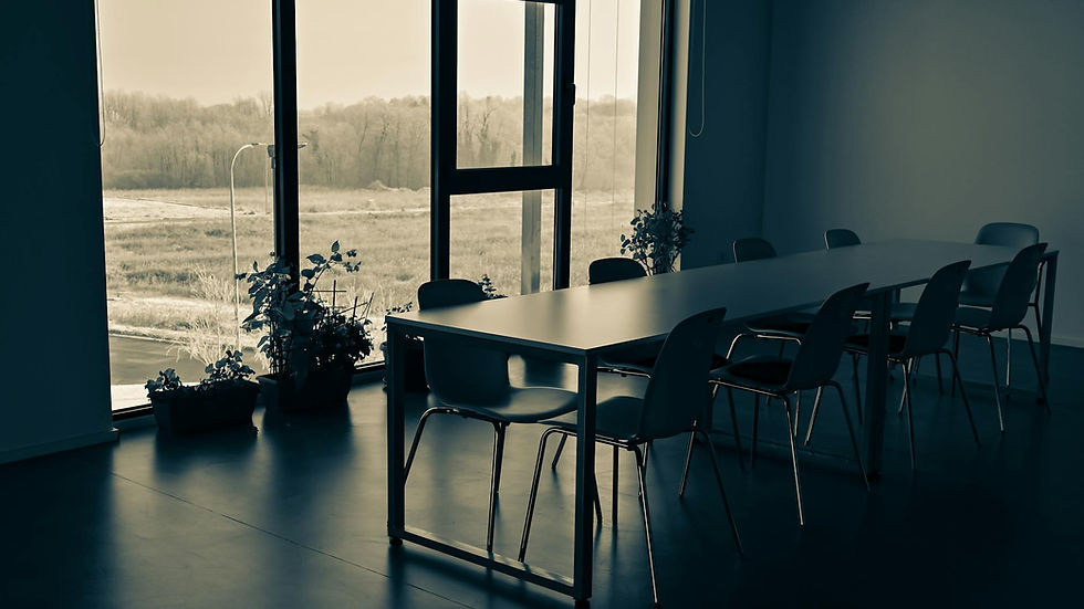 Empty conference room with a large window and plants, located in Garešnica, Croatia.