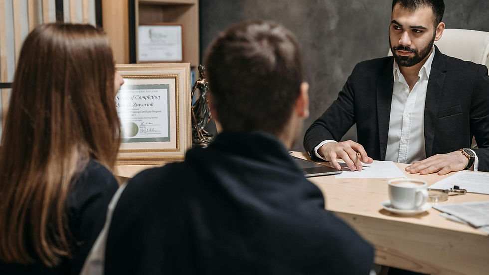 A lawyer in an elegant office meeting with clients, discussing documents.