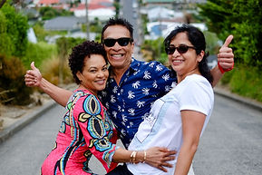 Small group of people enjoying a photo at the top of the steepest street in the world Balwin Street in Dunedin NZ