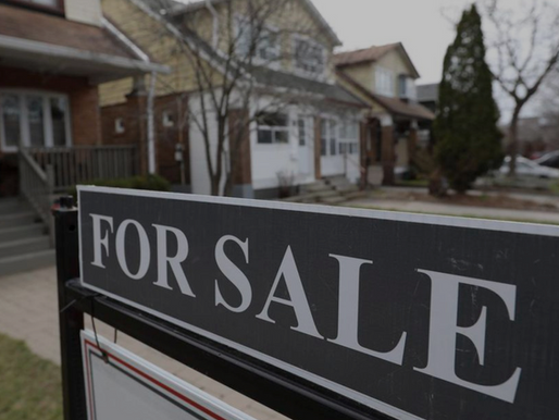 For sale sign in front of Toronto homes, reflecting a cooling real estate market and concerns around negative equity mortgages in mid-2025.