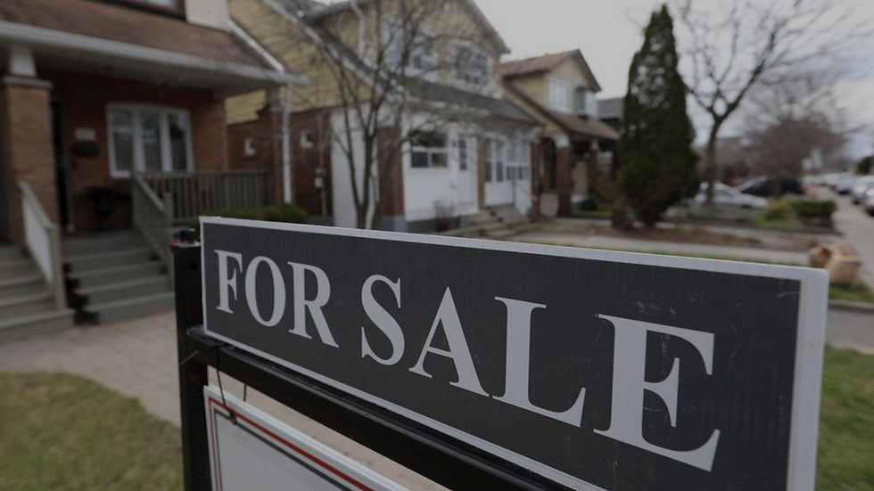 For sale sign in front of Toronto homes, reflecting a cooling real estate market and concerns around negative equity mortgages in mid-2025.