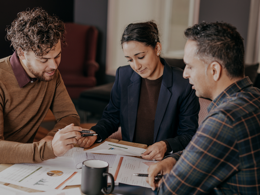 Mortgage advisor meeting with Toronto homeowners to discuss second mortgage options and equity strategies for debt consolidation or renovation financing.