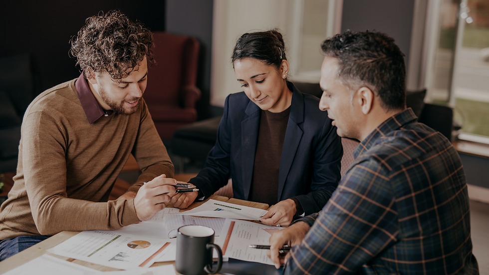 Mortgage advisor meeting with Toronto homeowners to discuss second mortgage options and equity strategies for debt consolidation or renovation financing.
