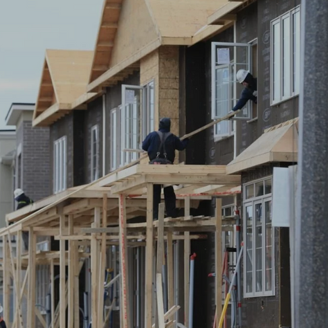 Construction workers building multi-unit rental housing, representing projects eligible for CMHC’s MLI Select financing program focused on affordability, energy efficiency, and accessibility.