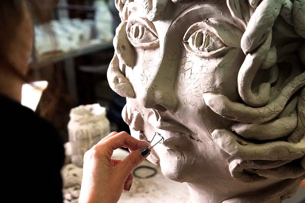 Close-up of a ceramic artist’s hands shaping a clay vase on a potter’s wheel