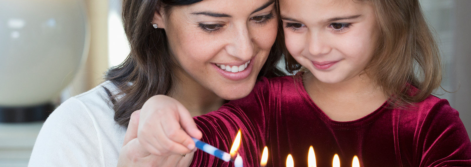 Mother and Daughter Lighting Candles