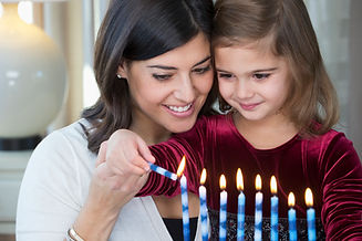 Mother and Daughter Lighting Candles
