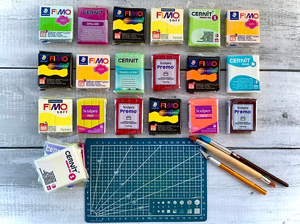 Colourful packs of polymer clay with sculpting tools and a cutting mat