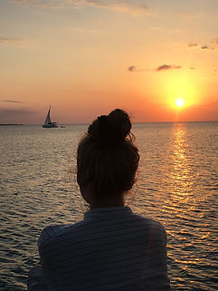 Mary watching the sunset over the sea
