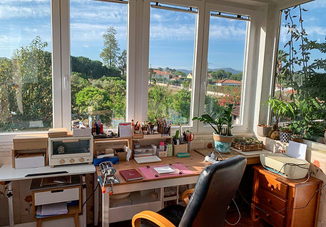 Mary Fox Art workspace with tools and supplies beside large windows