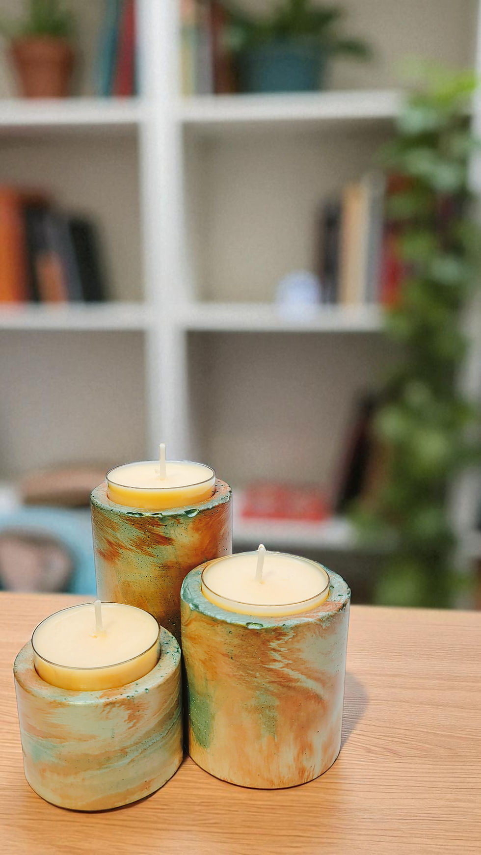 Three coral and green marbled cylindrical tea light holders