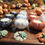 Thumbnail: Set of three Pumpkin Apple Butter candles in handmade cement pumpkin vessels – orange, white, and black