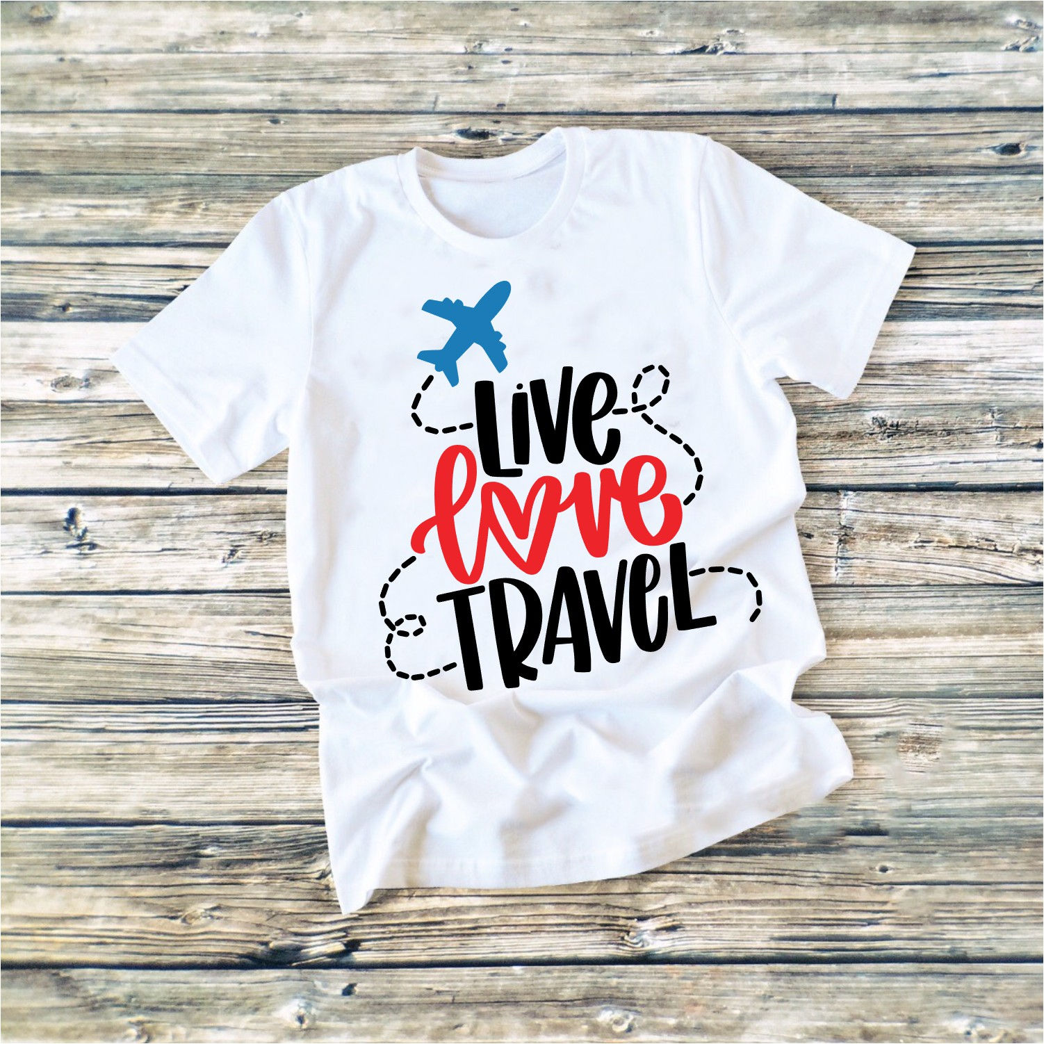 White t-shirt with text reading Live Love Travel with a graphic of a plane, smoke trail, and heart.