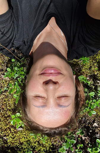 A woman lying on moss