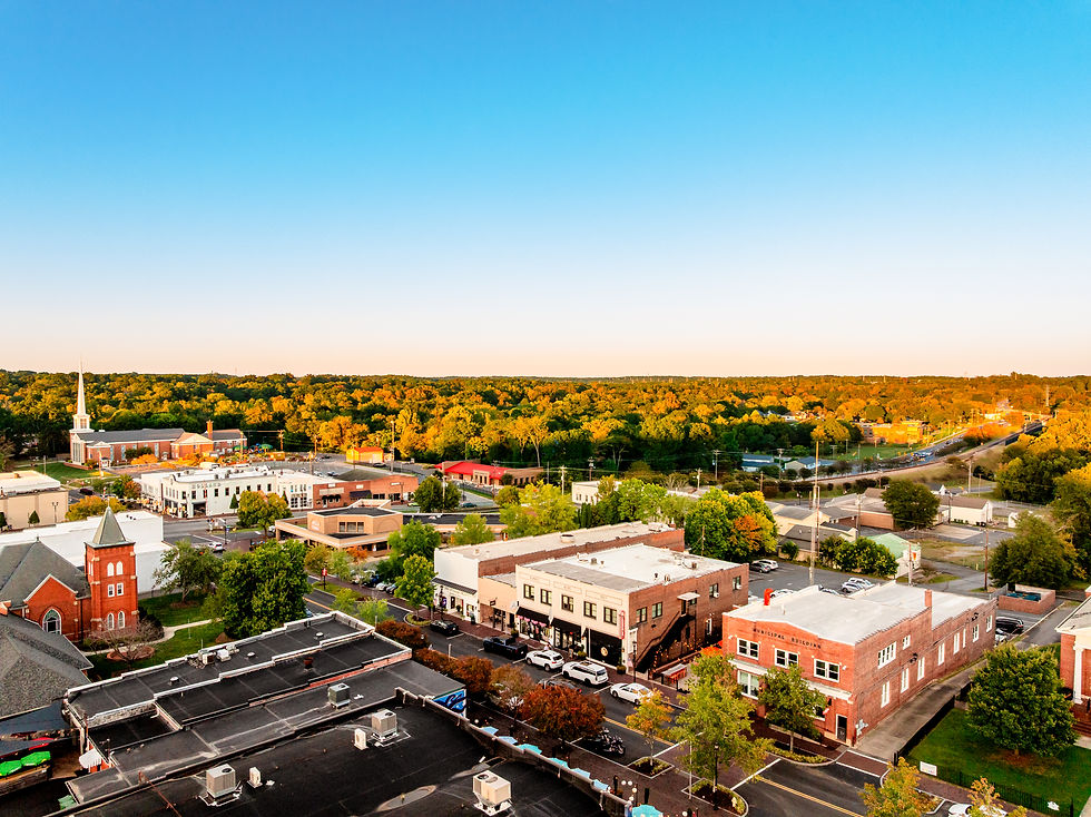 Jonathan, owner of The Summit Beer Shop in Mount Holly, smiling behind the bar
