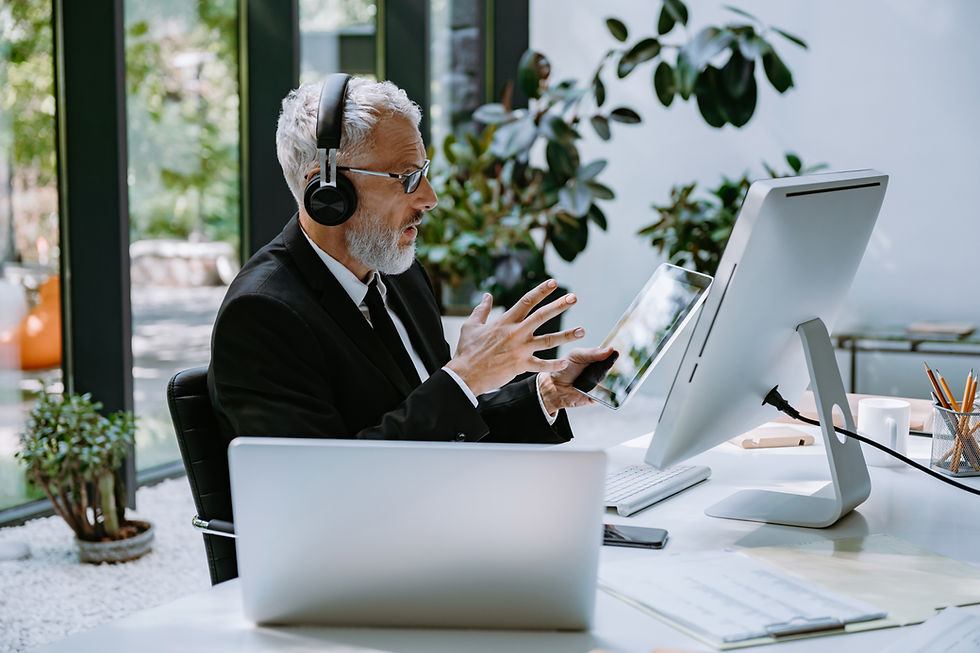 A man using his hands to explain something on a call on the computer