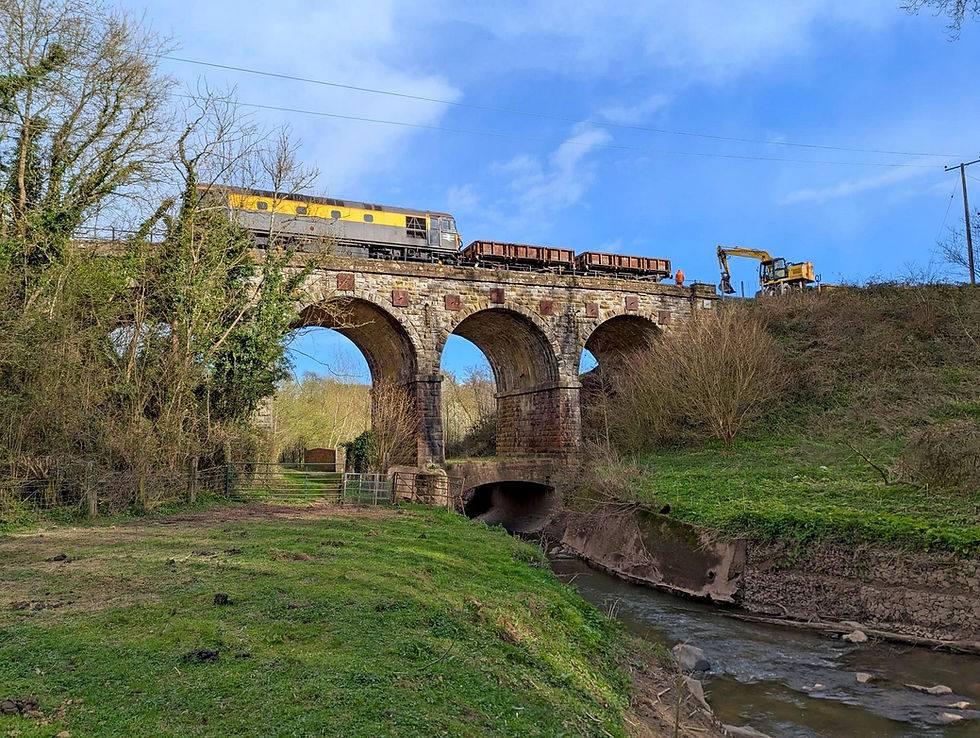 The resident Class 33, No 33108, on Borle Viaduct, with two 'Rudd' wagons of spoil for infilling.