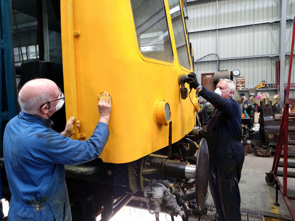 August 29. Neil Carter and Keith Bullock painting the yellow front of the DMU. Roland Bull