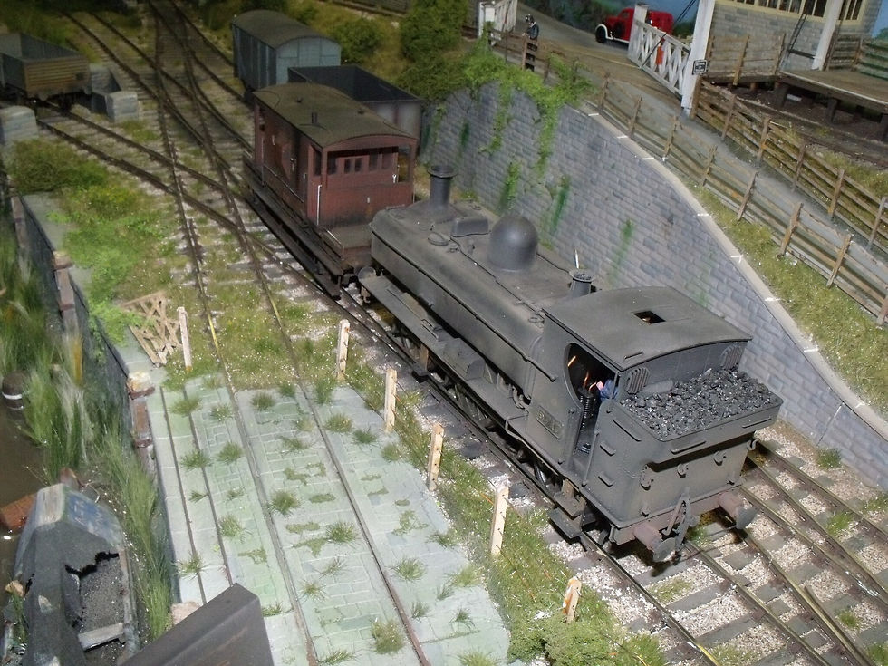 The O gauge 'Spetchley Halt' layout with 5717 shunting a BR brake van. Peter Hudson