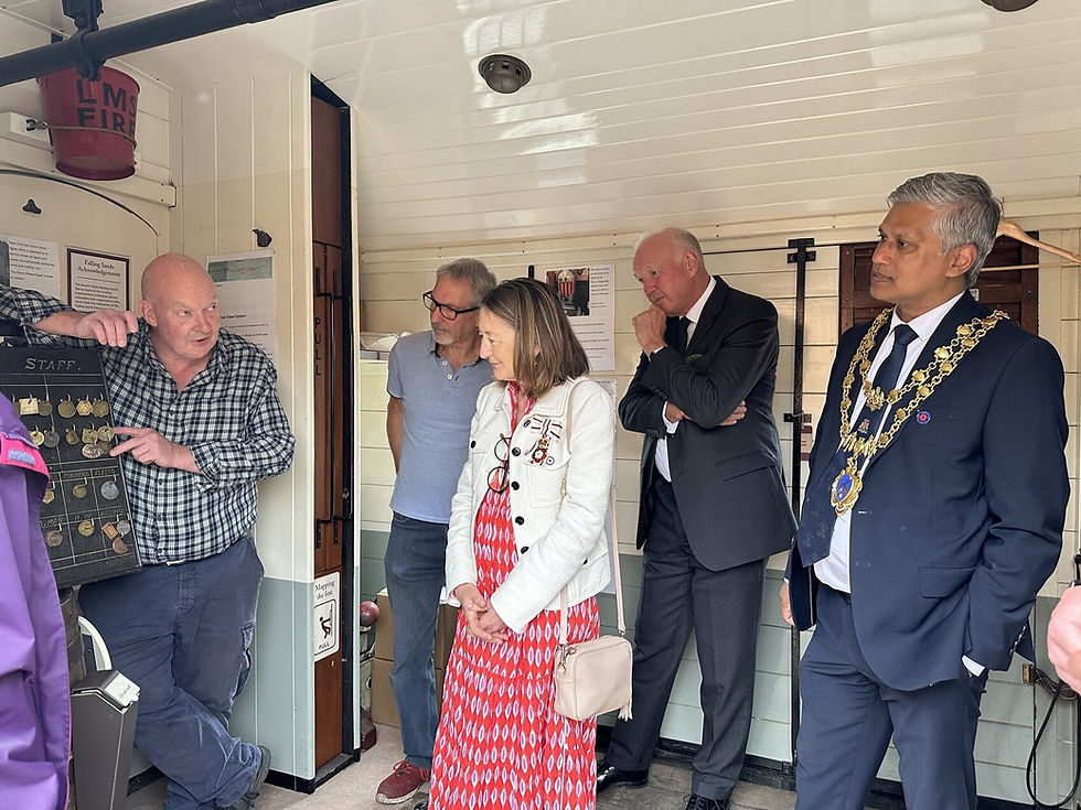 Volunteer Russell Dunn tells the visitors the history and heritage of the railway. Keith Wilkinson