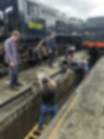 Volunteers emptying the pit by hand when the pump failed. MARTIN WHITE