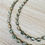Thumbnail: Sea Green And Grey Long Crystal Strand.