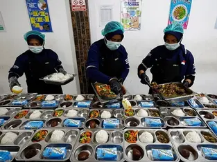 Workers prepare meals to be distributed free for students, during the free nutritious meals program trial, at a pilot kitchen in Sukabumi, West Java province, Indonesia in 2024