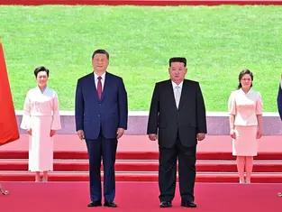 Chinese President Xi Jinping and North Korean leader Kim Jong Un watch a march-past as Kim holds a welcome ceremony for Xi at Kim Il Sung Square in Pyongyang, North Korea June 8, 2026