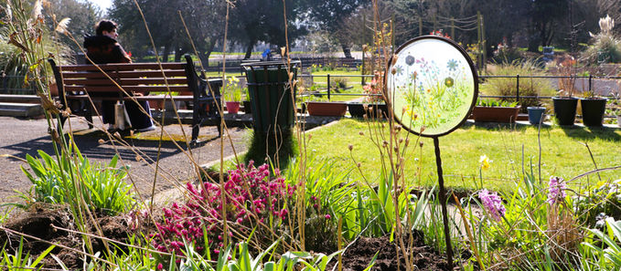 Woman sitting on a bench at Ashton Walled Garden