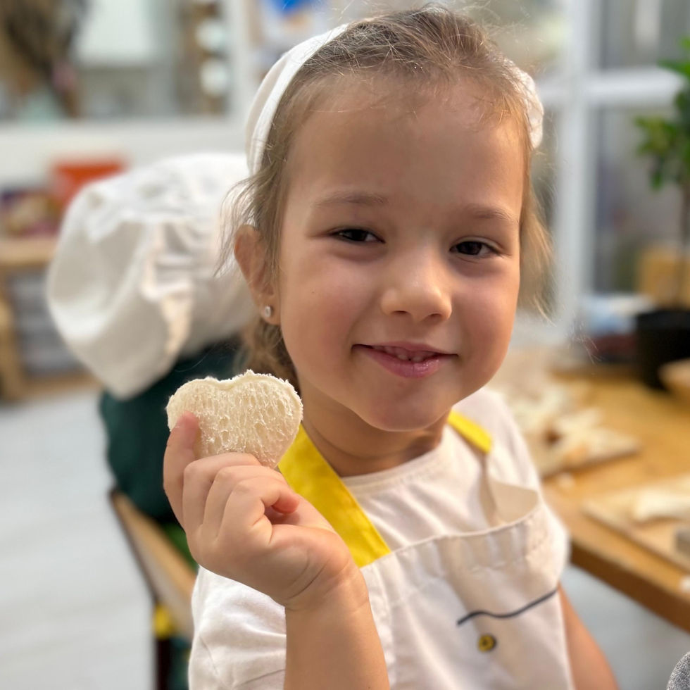 young girl holding cookie at a nursery in dubai : roots montessori nursery