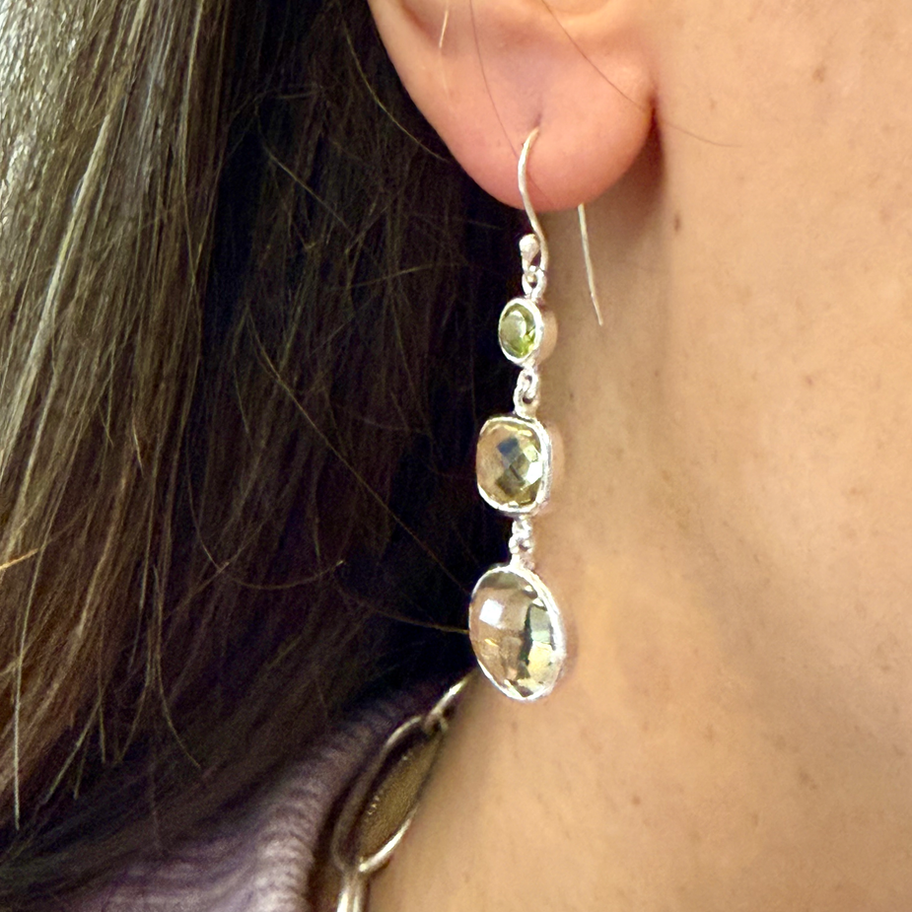 Peridot, Lemon Quartz and Green Amethyst Earring worn on an ear, showing the green and yellow gemstone drops.