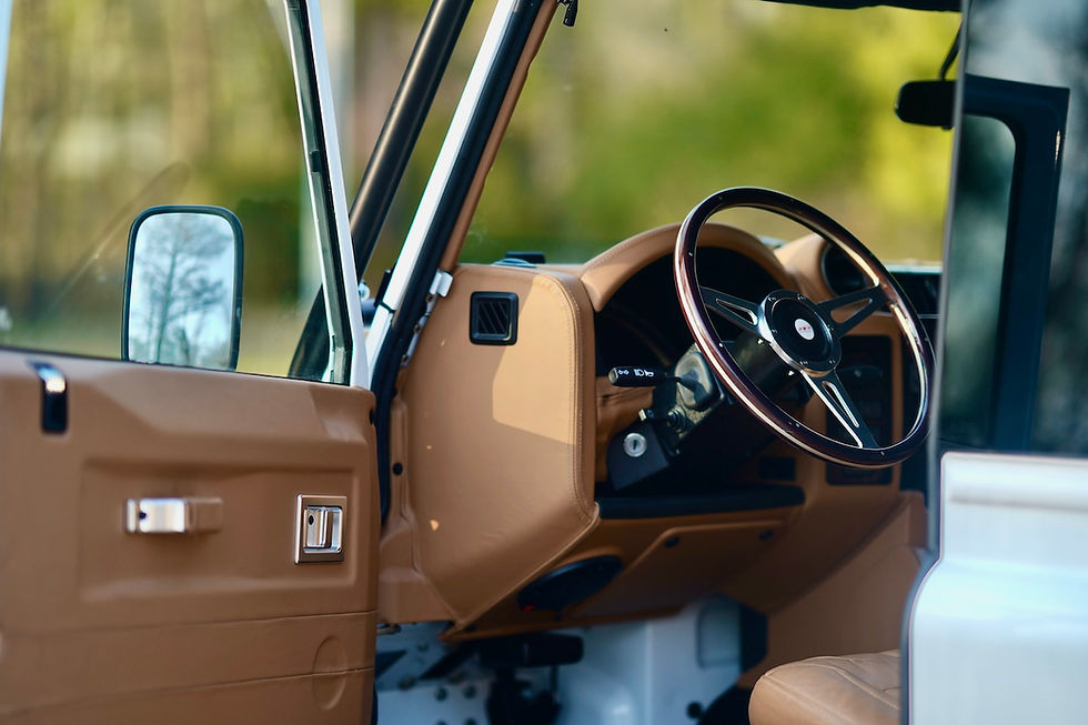 Tan leather interior and steering wheel of a classic SUV
