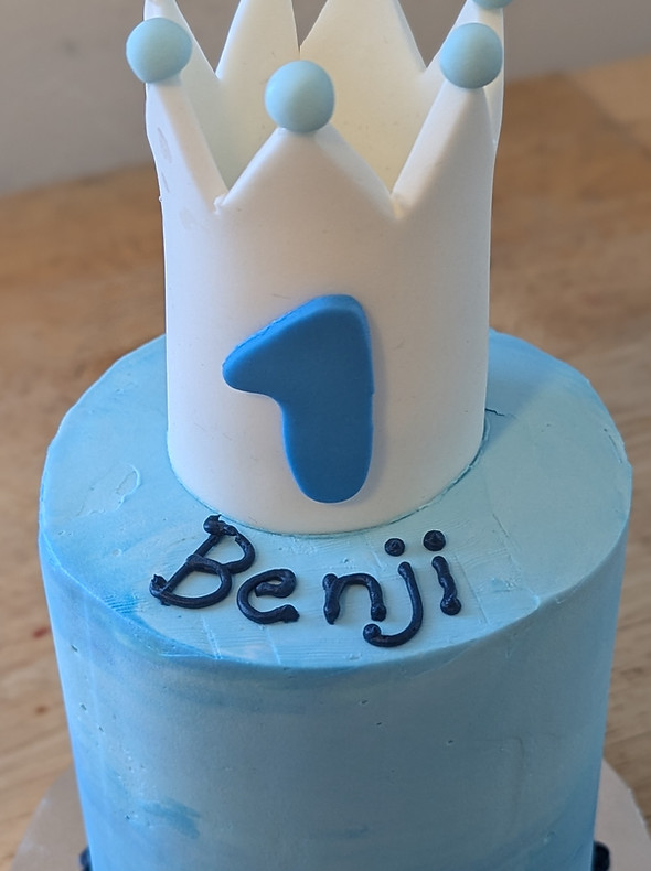 A blue Prince themed four inch three layer smash cake for a boy’s first birthday party. It has a cute white crown on top.
