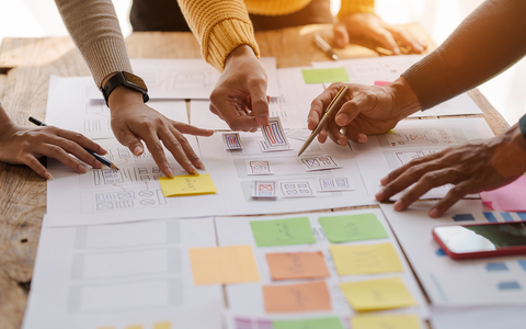 UX Research Cover - Image showing people conducting a research exercise. 