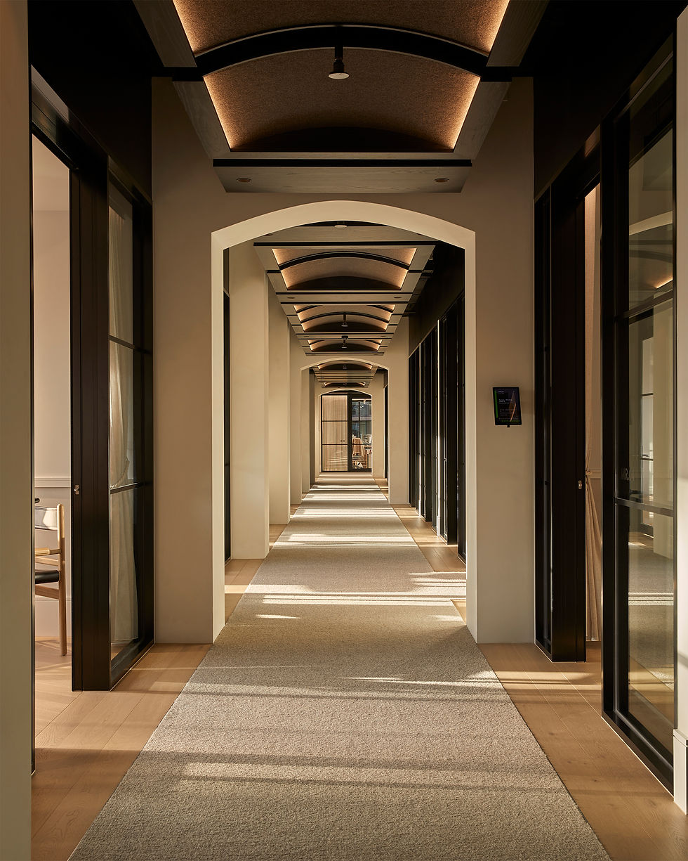 The Bureau workspace corridor at Eclat Hawthorn East — arched, softly-lit ceiling and glass-walled private offices