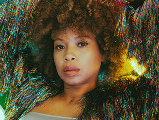 Woman wearing dramatic multicoloured metallic fringe fashion